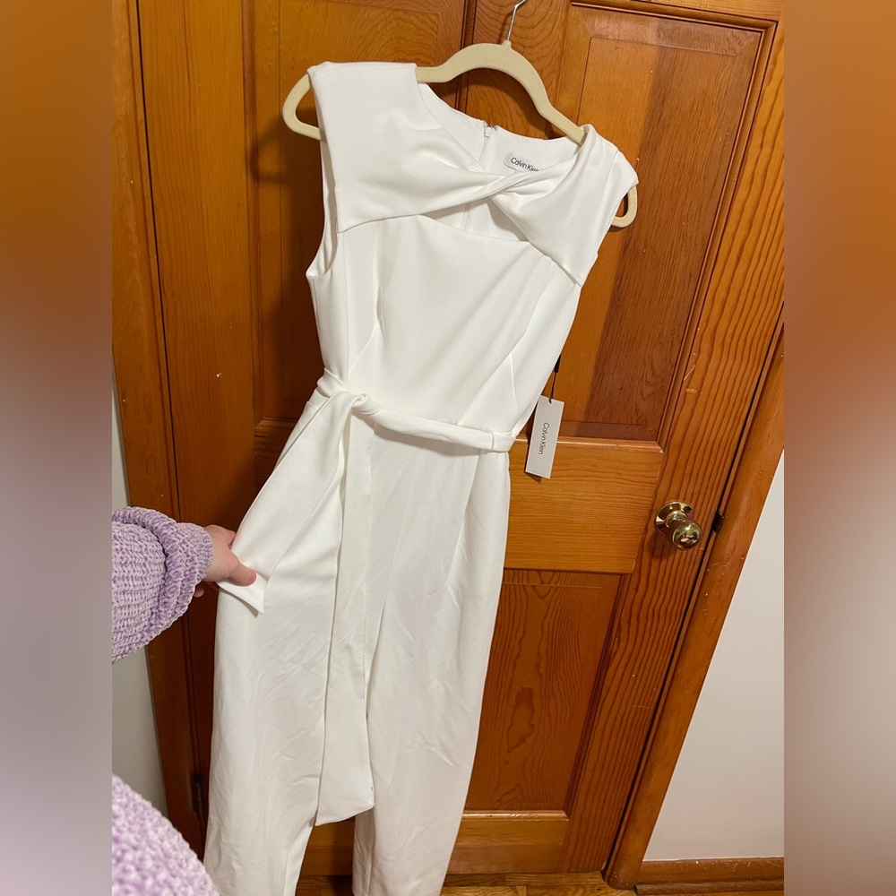 New with tags. Size six Calvin Klein white jumpsuit.